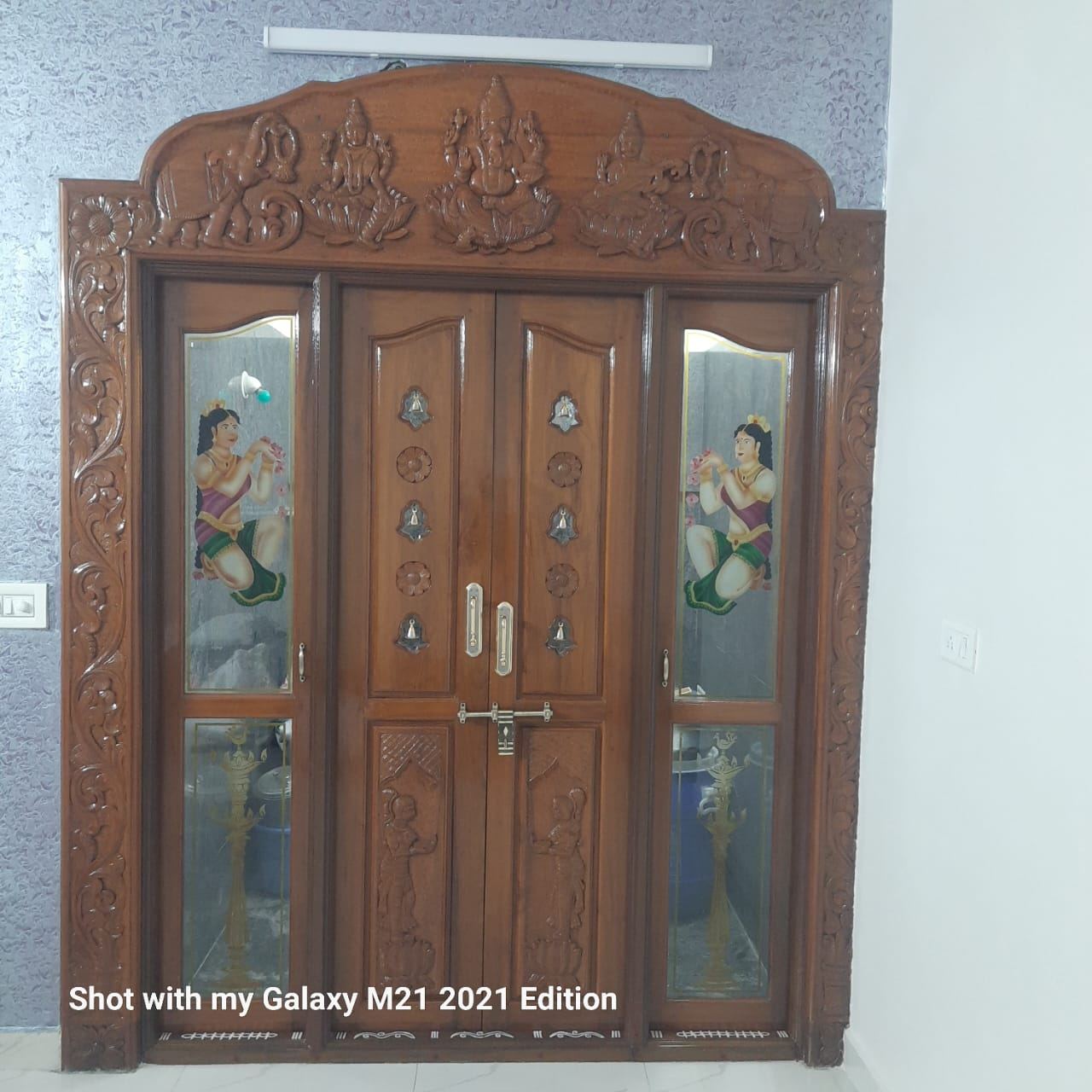 Carved teak pooja room doors with painted glass side lights