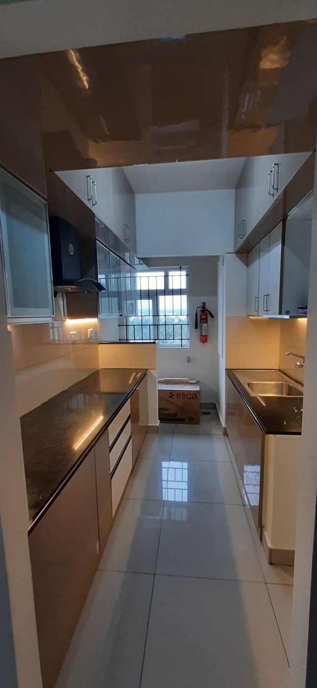 Galley modular kitchen with gloss shutters both sides, chimney and granite counters